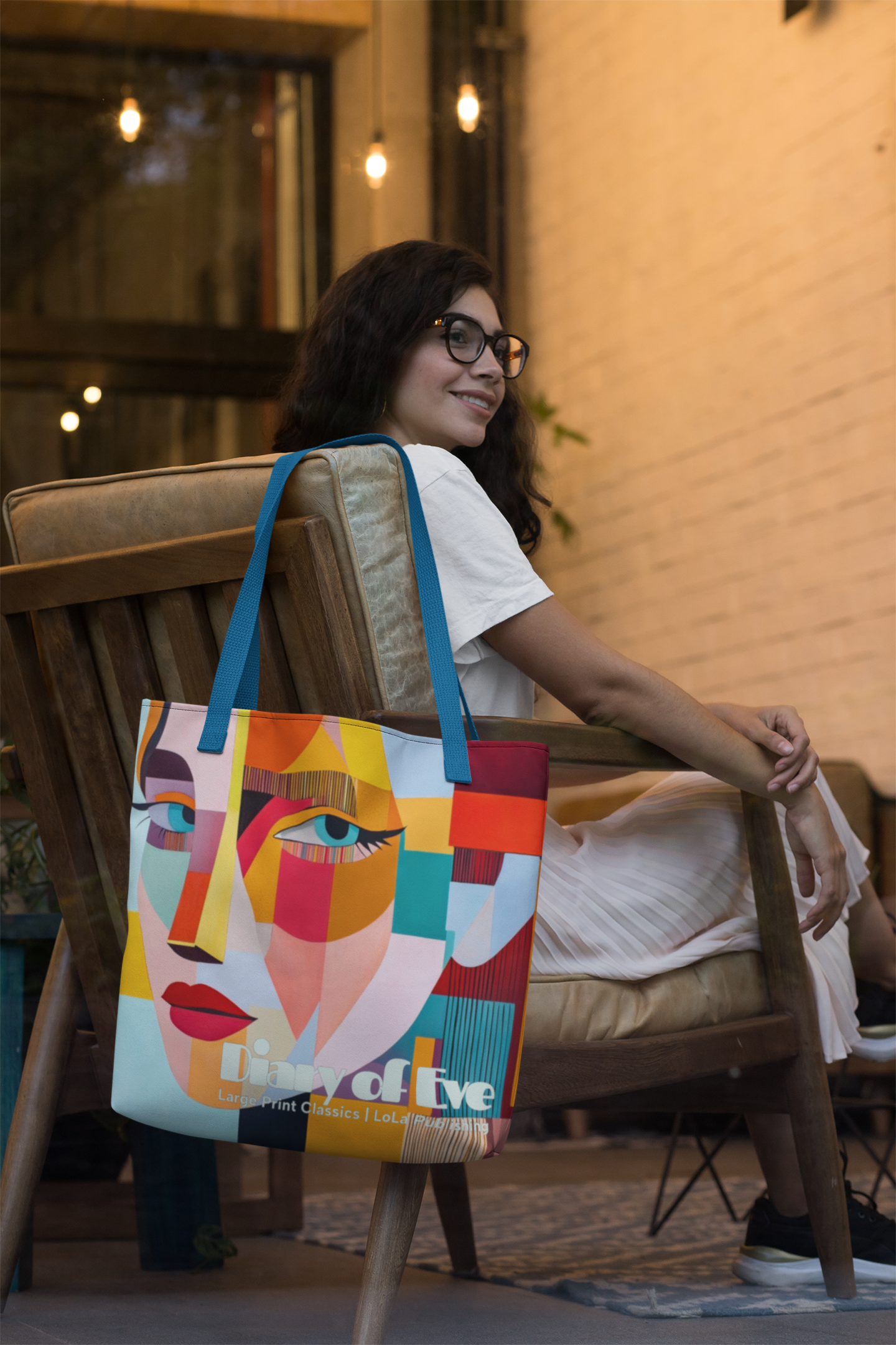 a-woman-with-glasses-sitting-on-a-chair-Eve-tote-bag-hanging